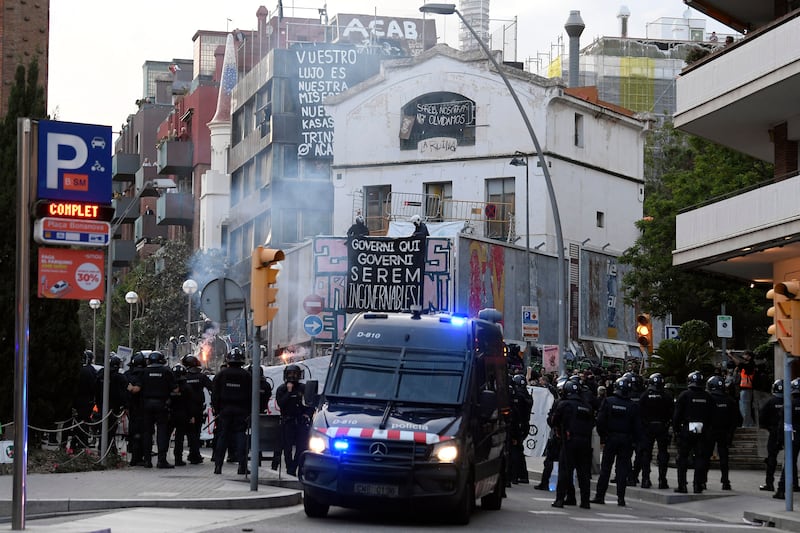 Members of the Catalan regional police forces, Mossos d'Esquadra, stand guard outside La Ruina and El Kubo squat houses in Barcelona. Photograph: Josep Lago/AFP via Getty Images