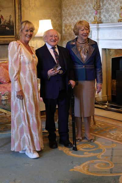 Valerie Hughes of the Irish Bernese Mountain Dog Club presenting President Michael D Higgins with a medal of appreciation 