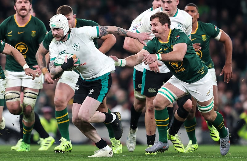 Mack Hansen is grabbed by South Africa's Kwagga Smith during Saturday's game. Photograph: Gary Carr/INPHO