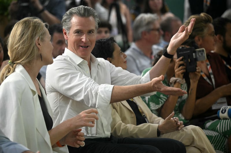 The governor of California Gavin Newsom speaks with a woman during the Cop30 conference, in Belem on Tuesday. Photograph: Mauro Pimentel/AFP via Getty