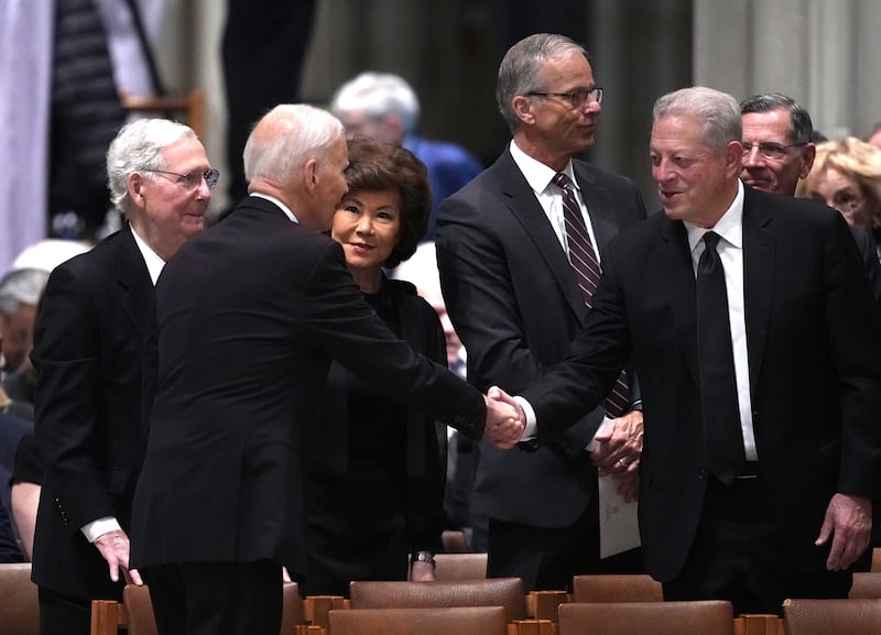 Former US vice-president Al Gore (right) greets Biden, as Republican senator Mitch McConnell and his wife Elaine Chao and US Senate majority leader John Thune stand by, during the funeral service. Photograph: Andrew Harnik/Getty Images