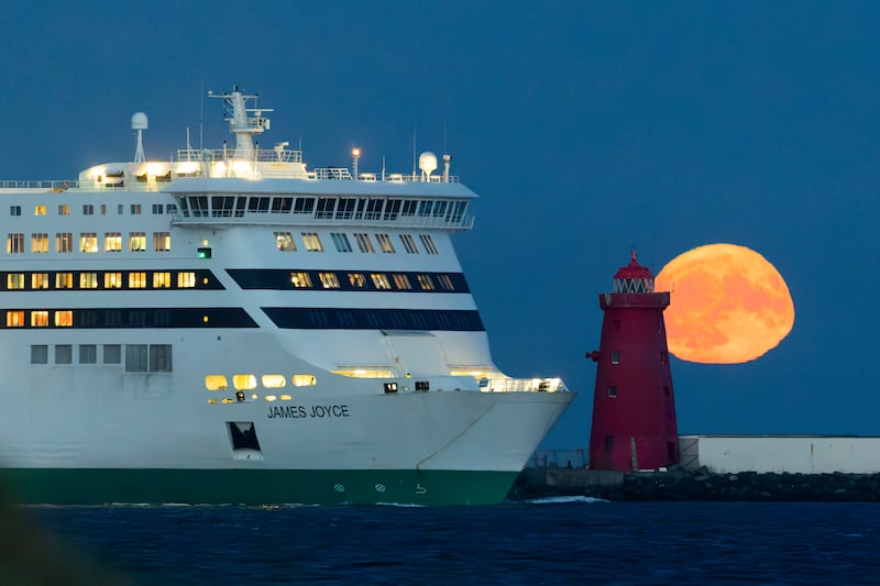 The buck moon rising over the Poolbeg Lighthouse in Dublin Bay as Irish Ferries vessel James Joyce passes. Photograph: Tom Honan