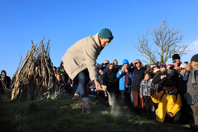 Aisling Rogerson scatters her late husband Manchán's ashes at his month’s mind. Photograph: Dara Mac Dónaill 










