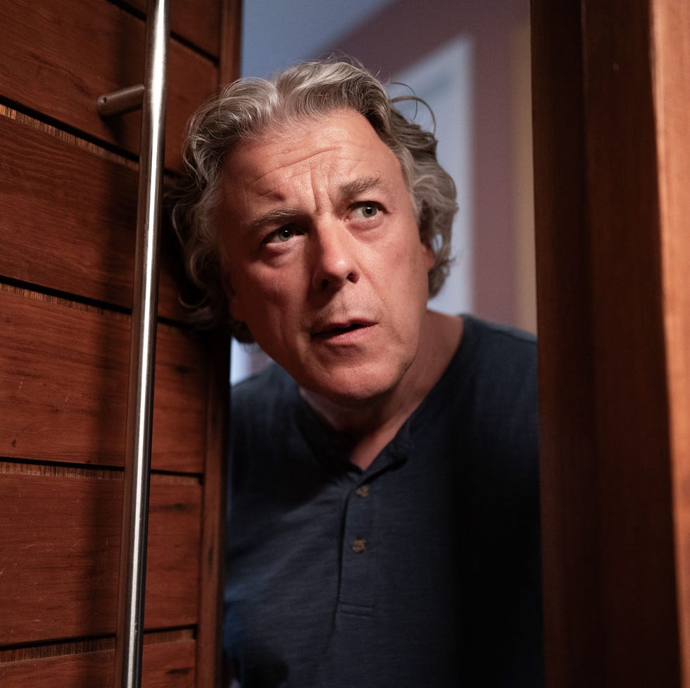 person peering through a doorway person peering through a doorway