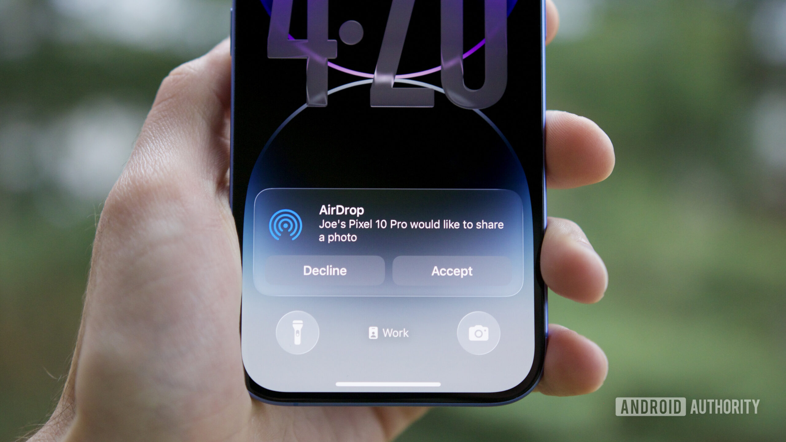 An iPhone with an AirDrop notification, showing a Pixel 10 shared a file with it.