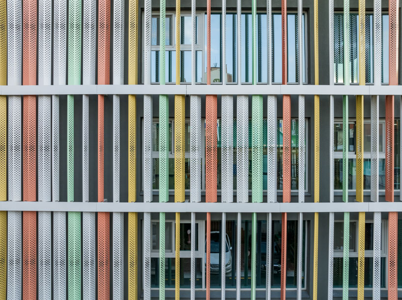translucent facade of multicolored steel louvers unfolds along seoul’s dokkaebi market