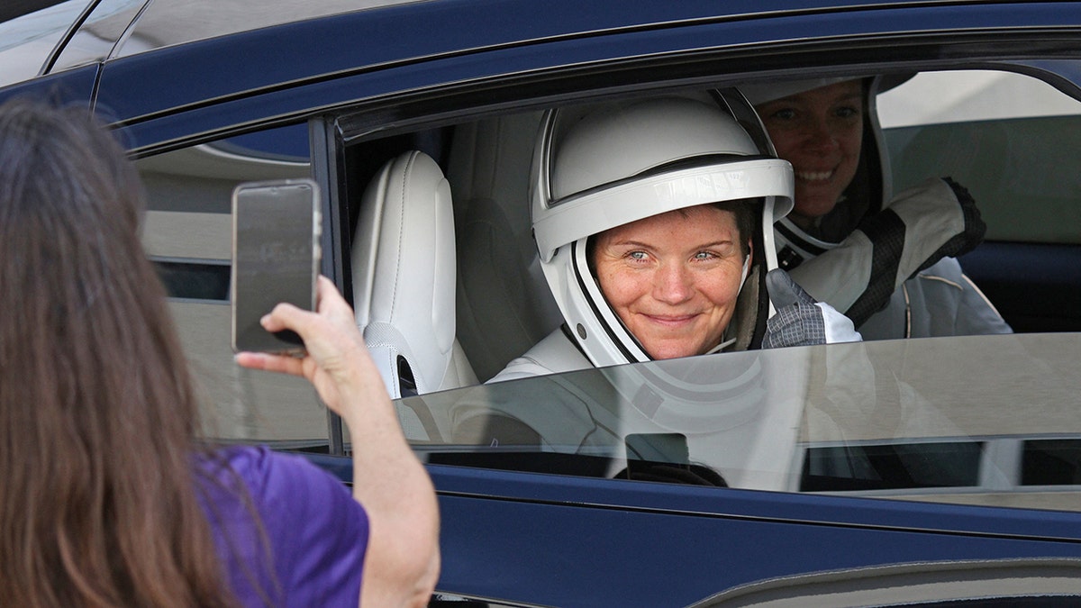 Anne McClain smiles before leaving on mission