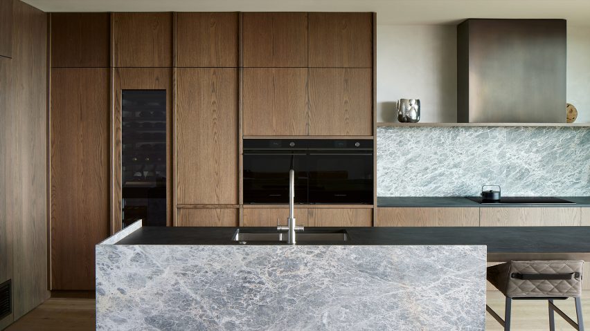 Oak and marble kitchen features appliances by Fisher & Paykel
