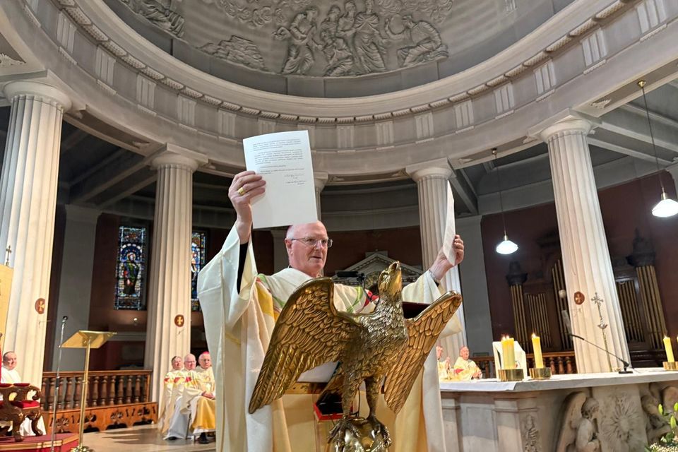 During Mass Archbishop Dermot Farrell holds up the decree of Pope Leo XIV designating St Mary’s as the Cathedral Church of the Archdiocese of Dublin. (Catholic Communications Office archive) (Catholic Communications Office archive)