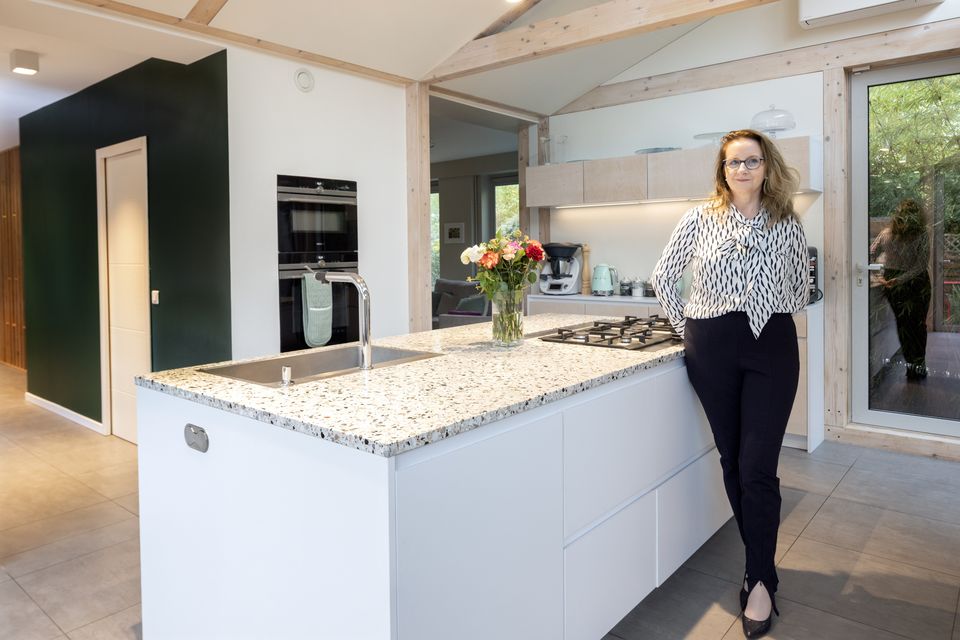 Jennifer O’Neill-Mardokh in her newly renovated home which was built with sustainability in mind – it’s a mainly wood structure with wool fibre insulation and has exposed wood beams and large expanses of glass. She loves her extra large terrazzo-topped island which houses both the sink and the gas hob. Photo: Tony Gavin