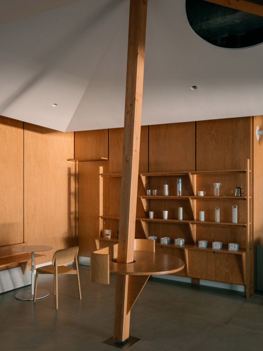 Wood panelled walls and matching storage in Shanghai coffee shop