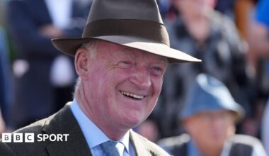 Willie Mullins smiles while wearing a hat