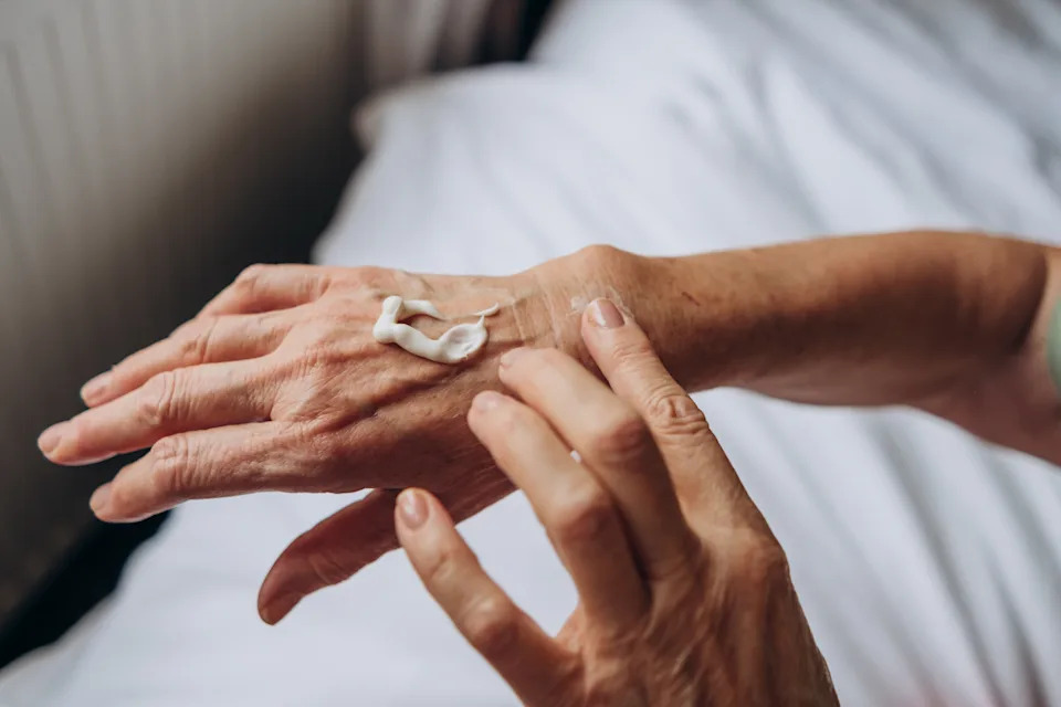 women senior takes care of herself
hand care
woman applying cream to her hands