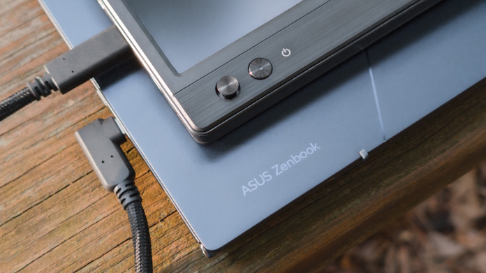 An ASUS ZenScreen portable monitor on top of an ASUS laptop