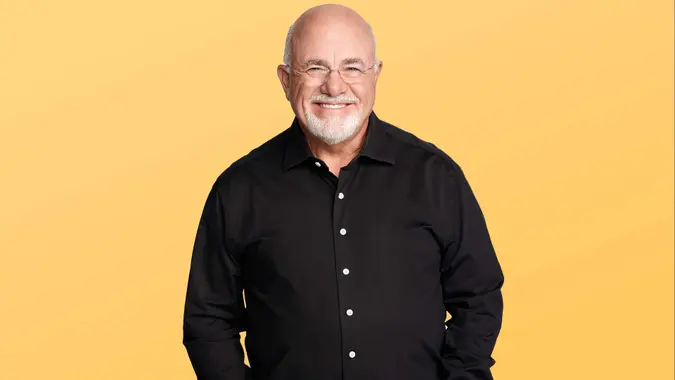 dave ramsey smiling at the camera while wearing a black button down shirt