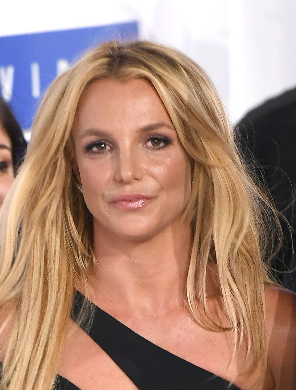 Britney Spears in a one shoulder top with long hair