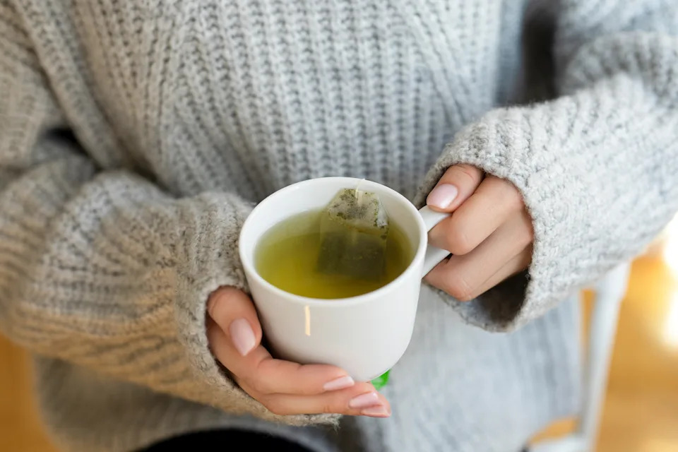 Female hands with cup of hot tea