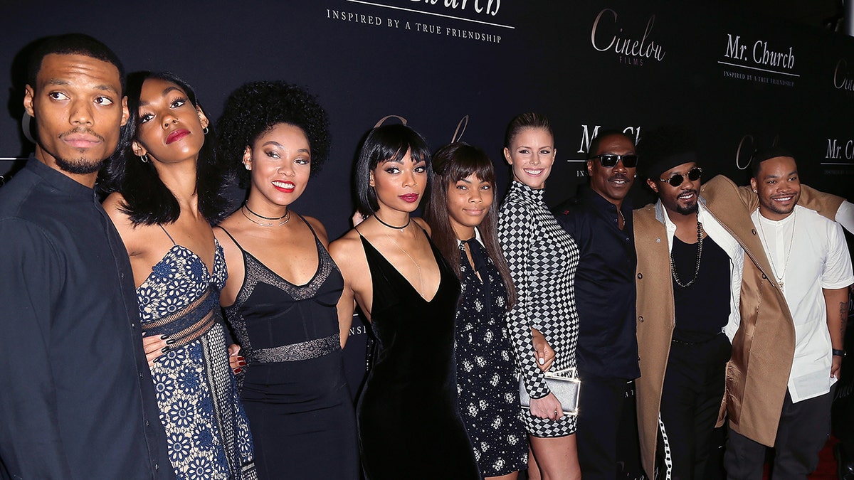 Eddie Murphy, Paige Butcher, and Murphy’s children pose together on the red carpet