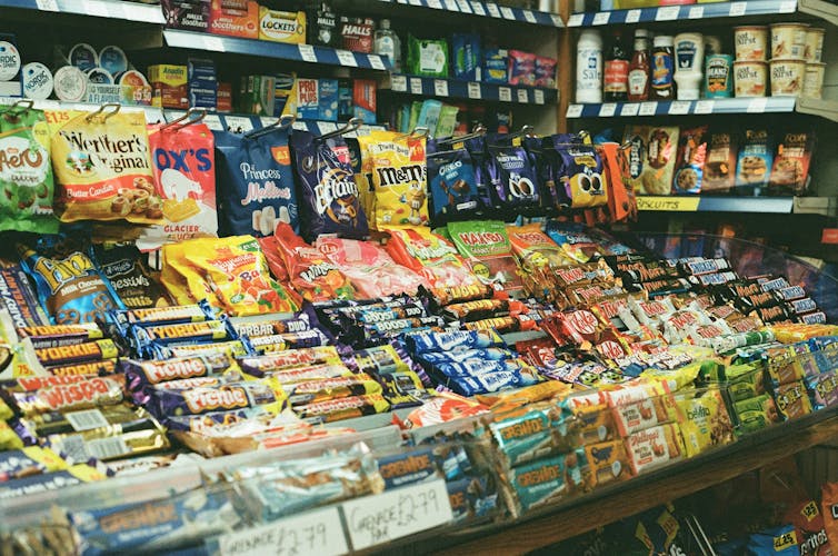 Lollies are placed on a shelf in a store.