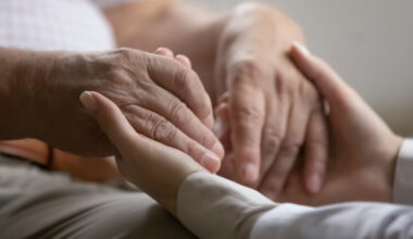 young hand holding older hands