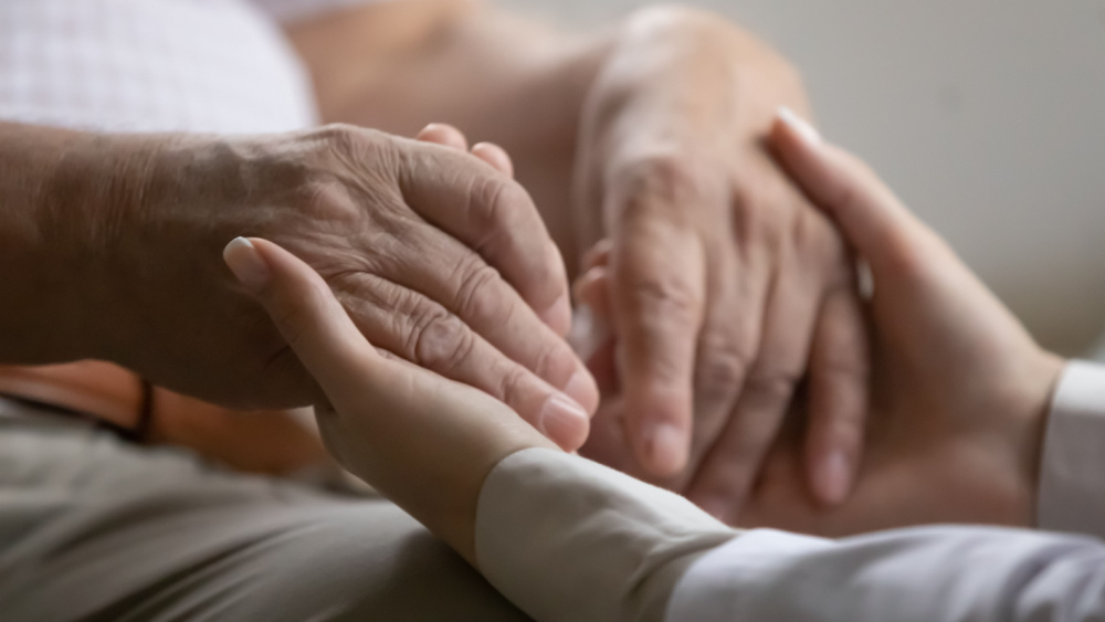 young hand holding older hands