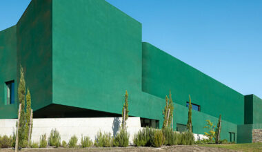 galeria gabinete’s green cork building fades into portuguese terrain