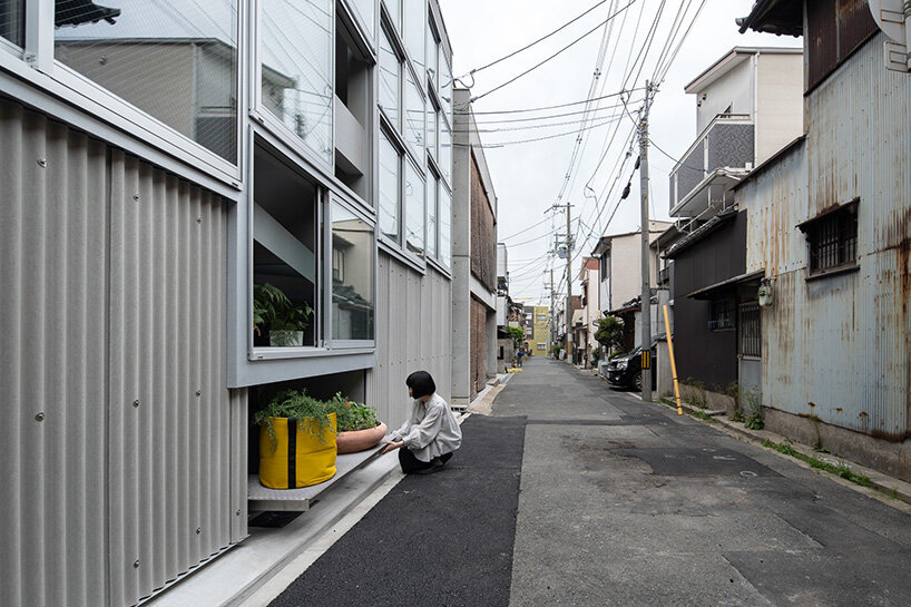 grid of operable windows fronts slender residence by okuwada architects in osaka