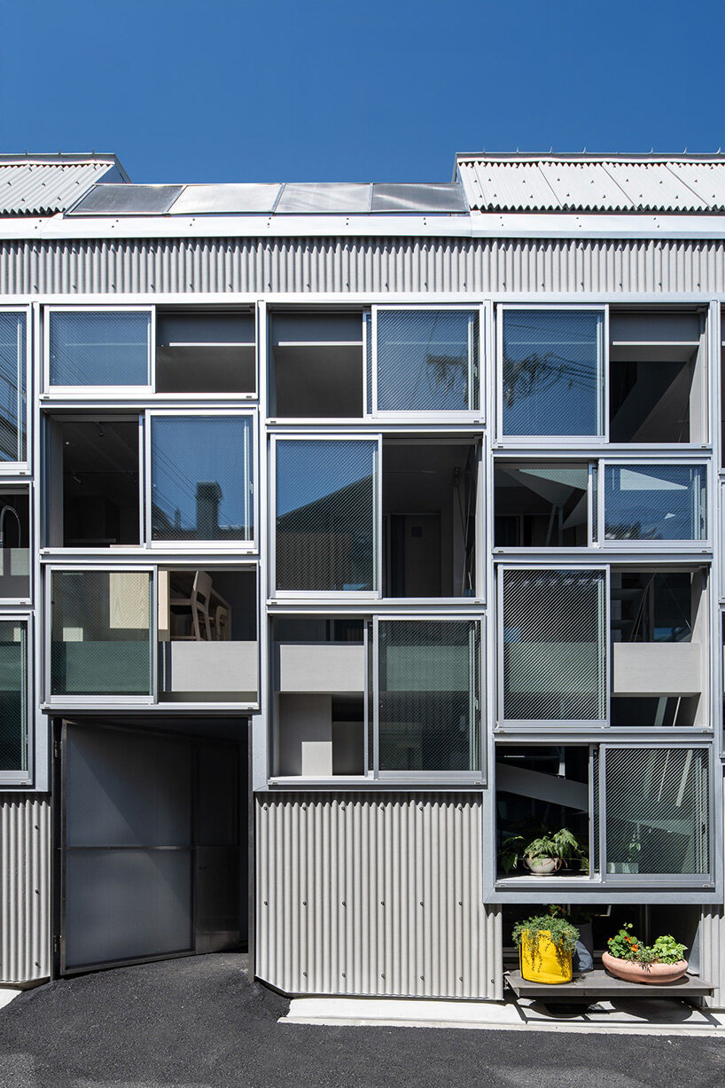grid of operable windows fronts slender residence by okuwada architects in osaka