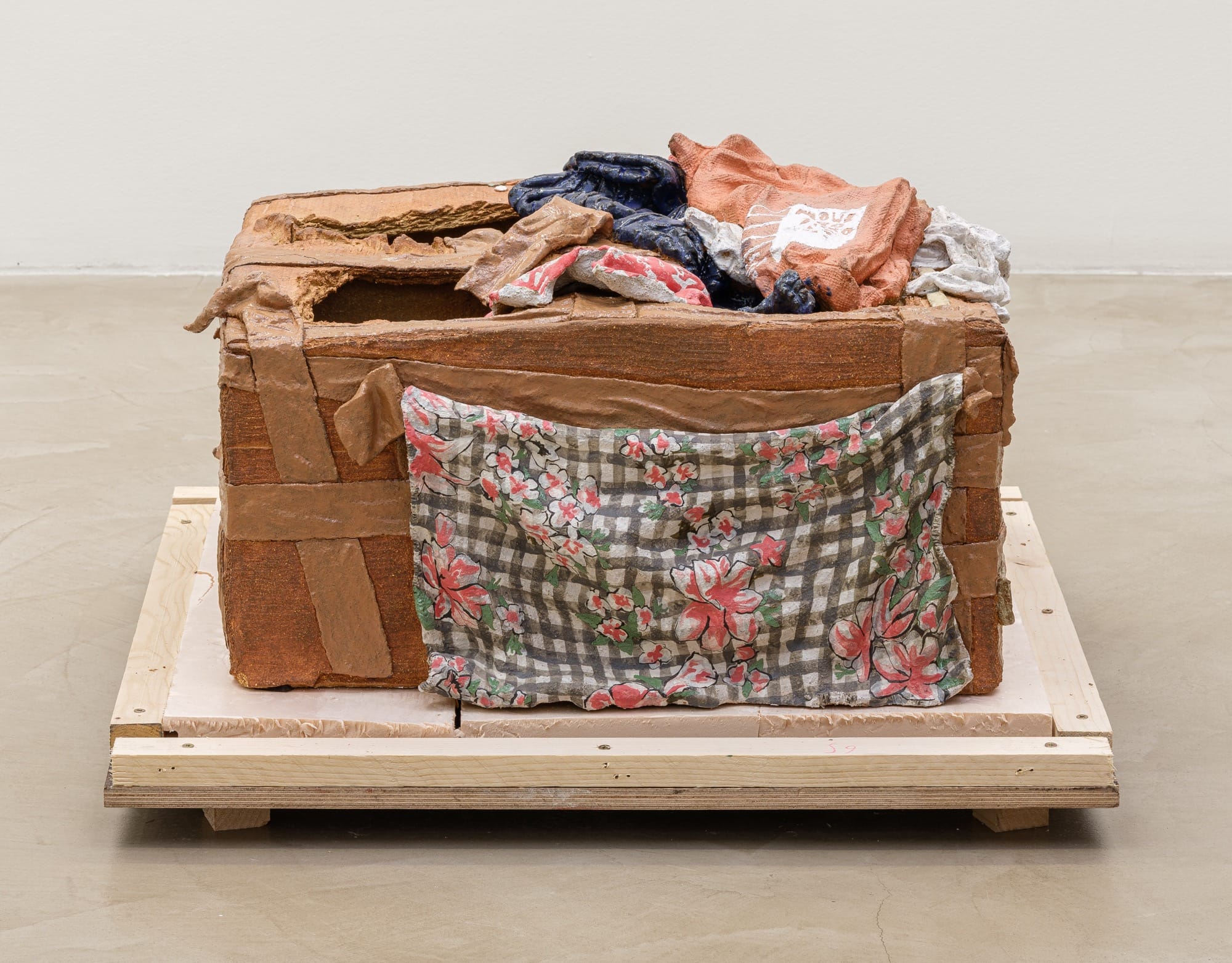 a sculpture by Ninon Hivert that mimics a stack of cardboard and other fabrics