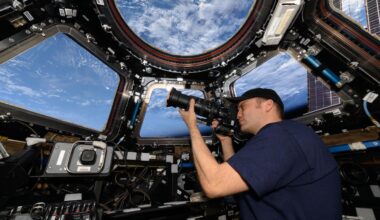 NASA astronaut Matthew Dominick points his camera through a cupola window as the International Space Station orbits 262 miles above the Atlantic Ocean off the coast of Africa.