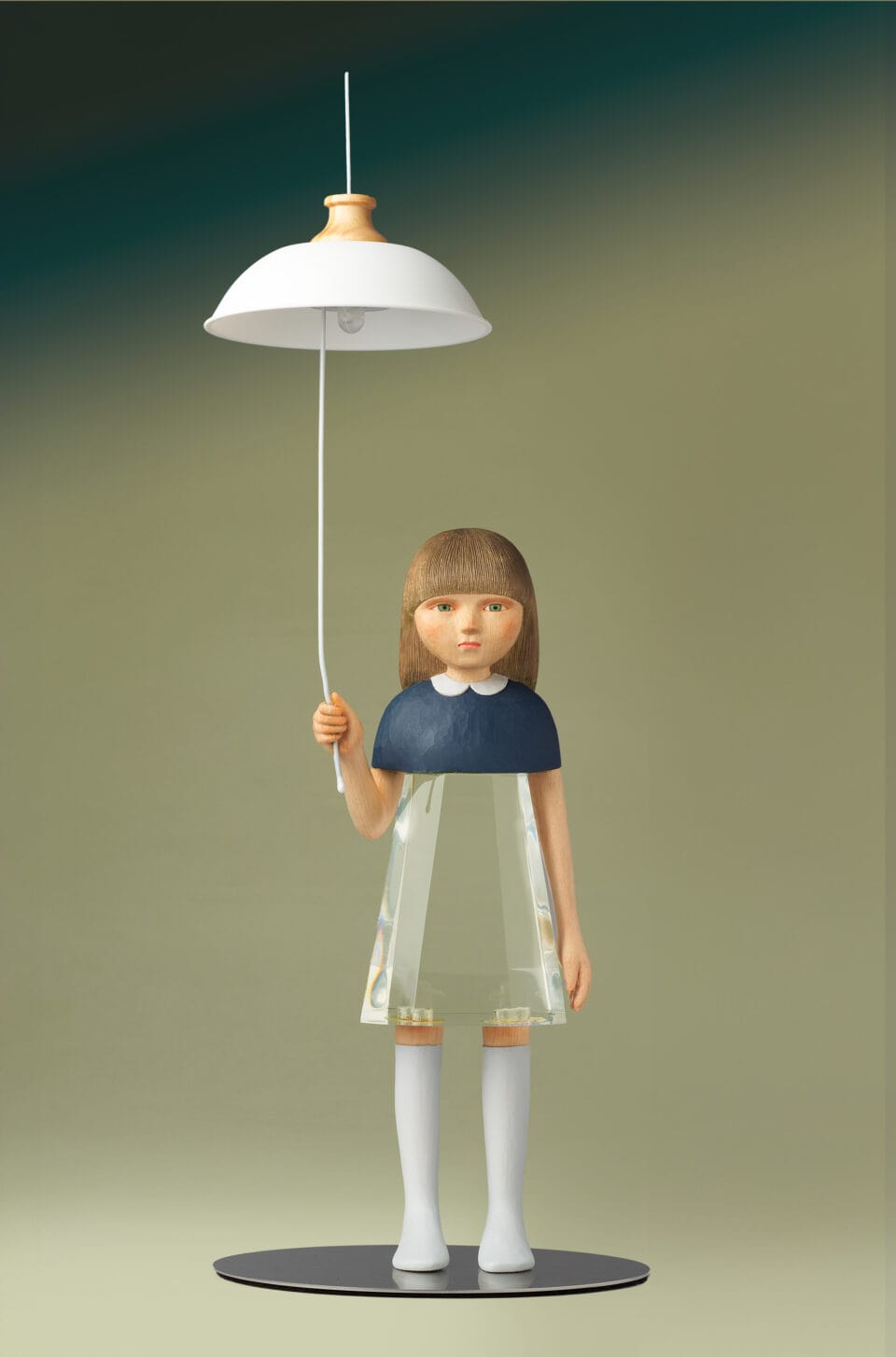 a small sculpture by Ayako Kita made of cypress and acrylic resin, depicting a young woman or girl holding the string of a ceiling light