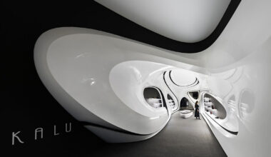 fluid black and white interiors connect curved mall corridors in tehran