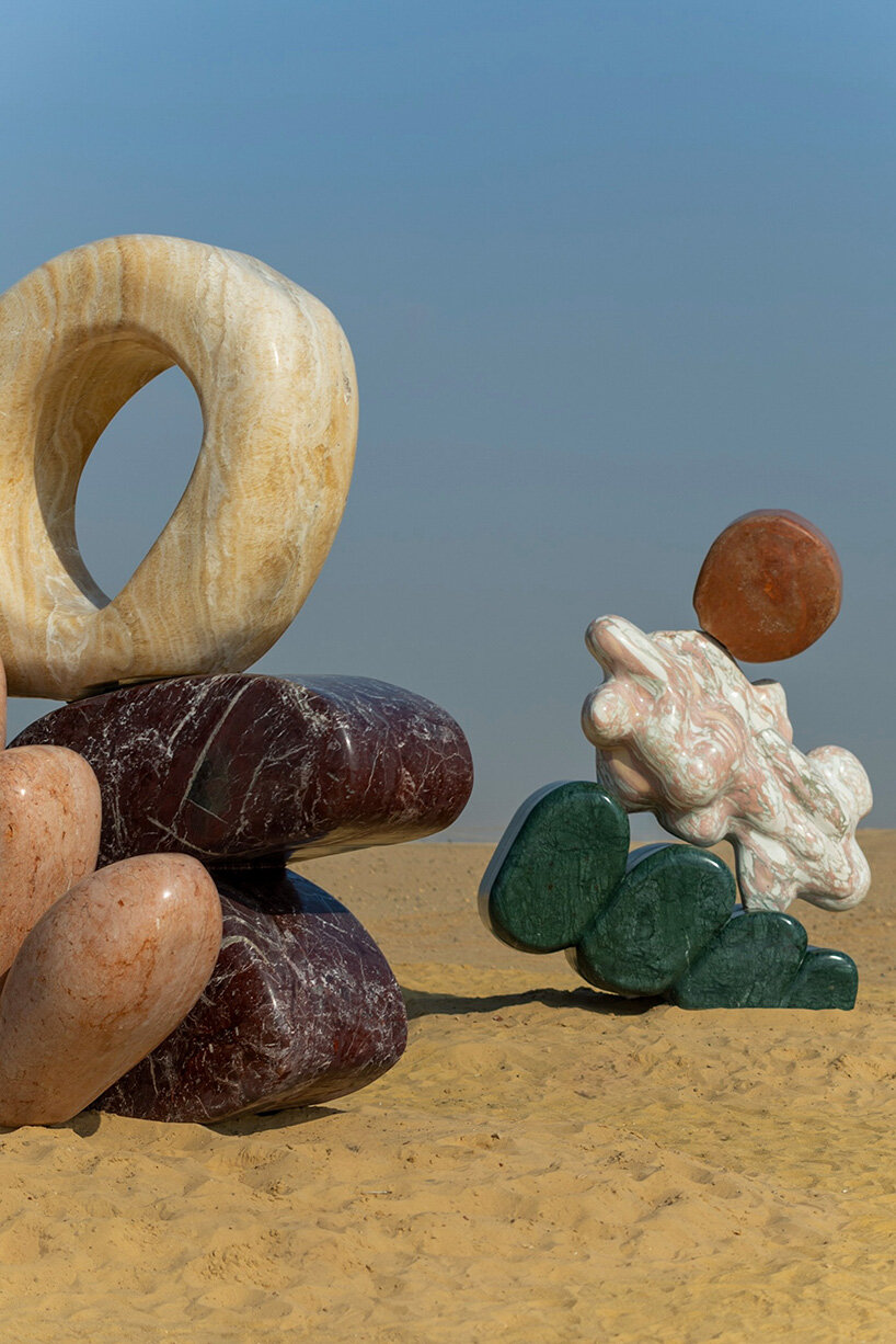 monumental stone sculptures by StudioPROBA and solidnature emerge across the pyramids