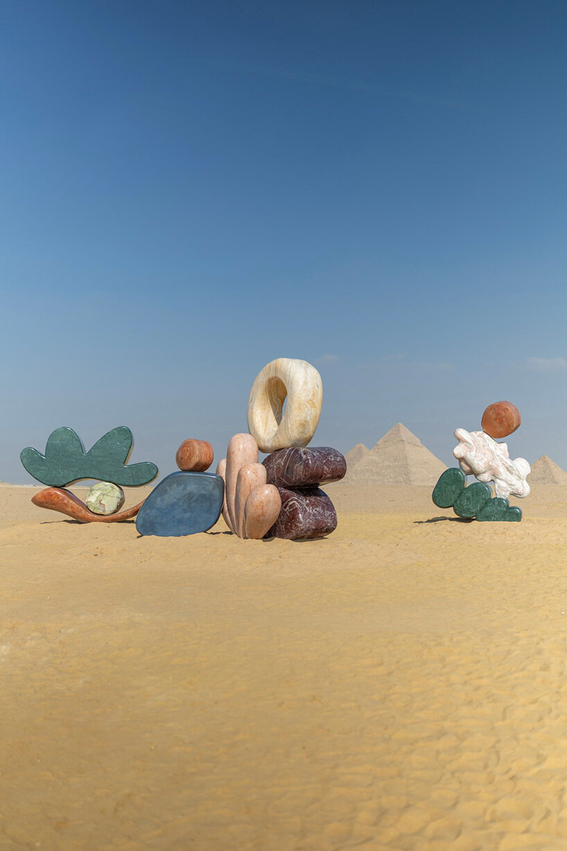 monumental stone sculptures by StudioPROBA and solidnature emerge across the pyramids