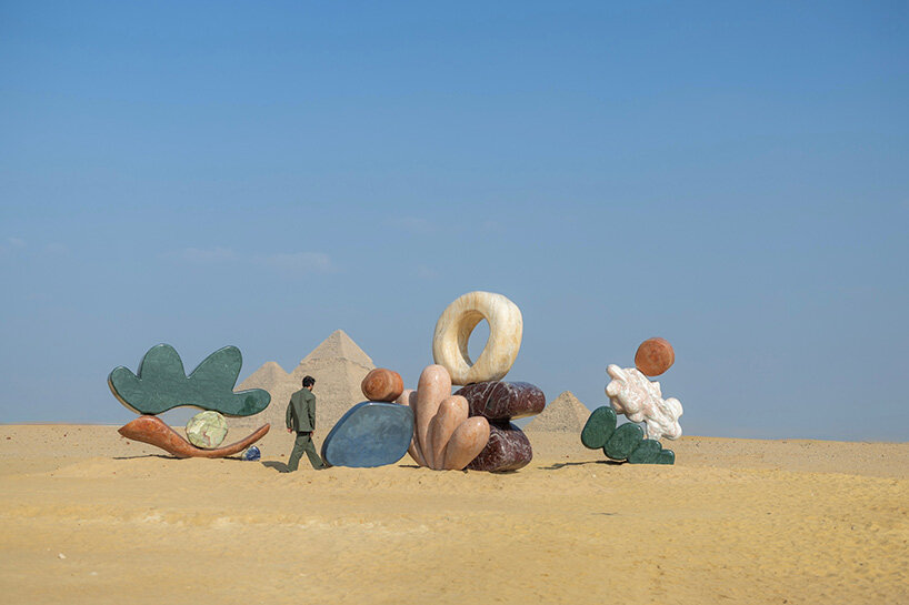 monumental stone sculptures by StudioPROBA and solidnature emerge across the pyramids