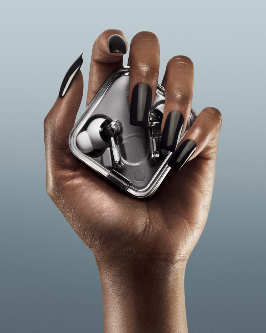 Hand holding headphone case by Nothing