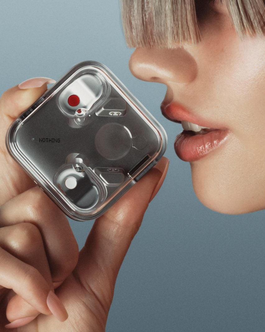 Person holding Ear (3) headphones case up to their mouth