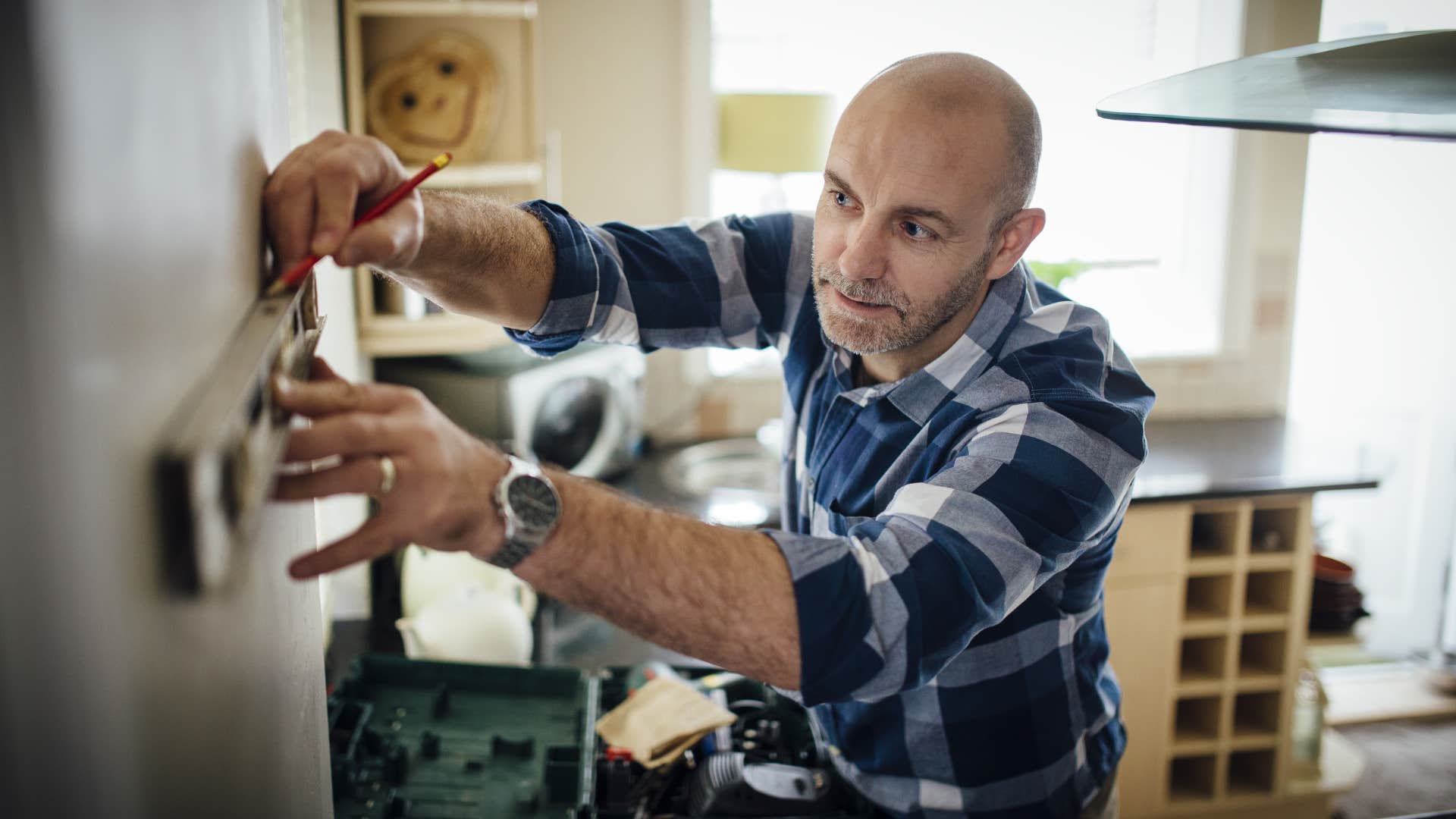 man creating diy decor for his home