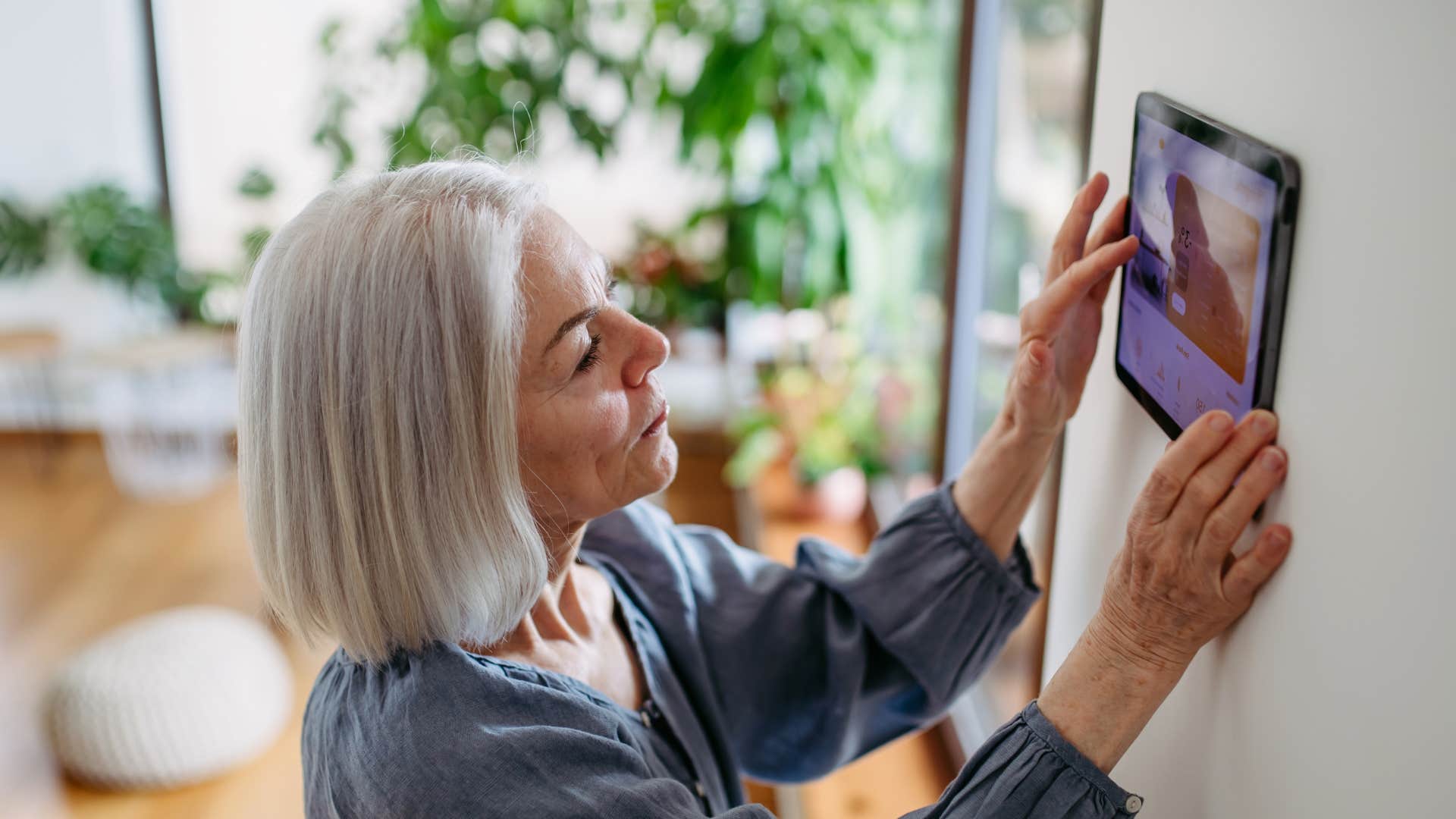 woman messing with the thermostat