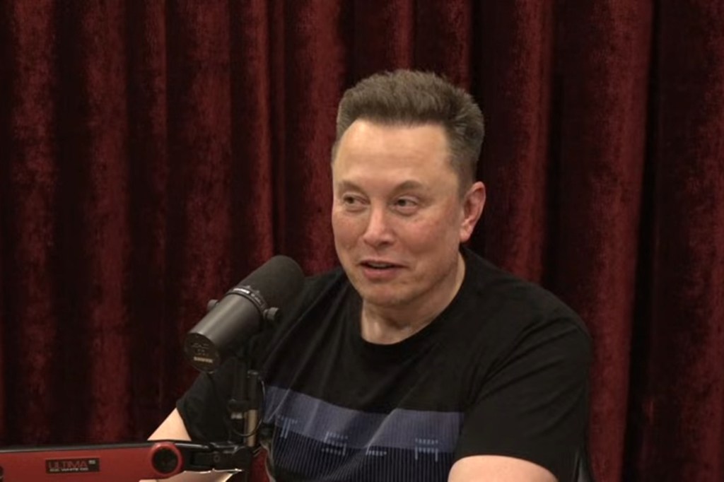 Elon Musk speaking into a microphone.