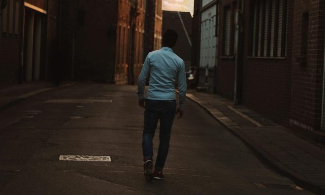 man walking outside birds
