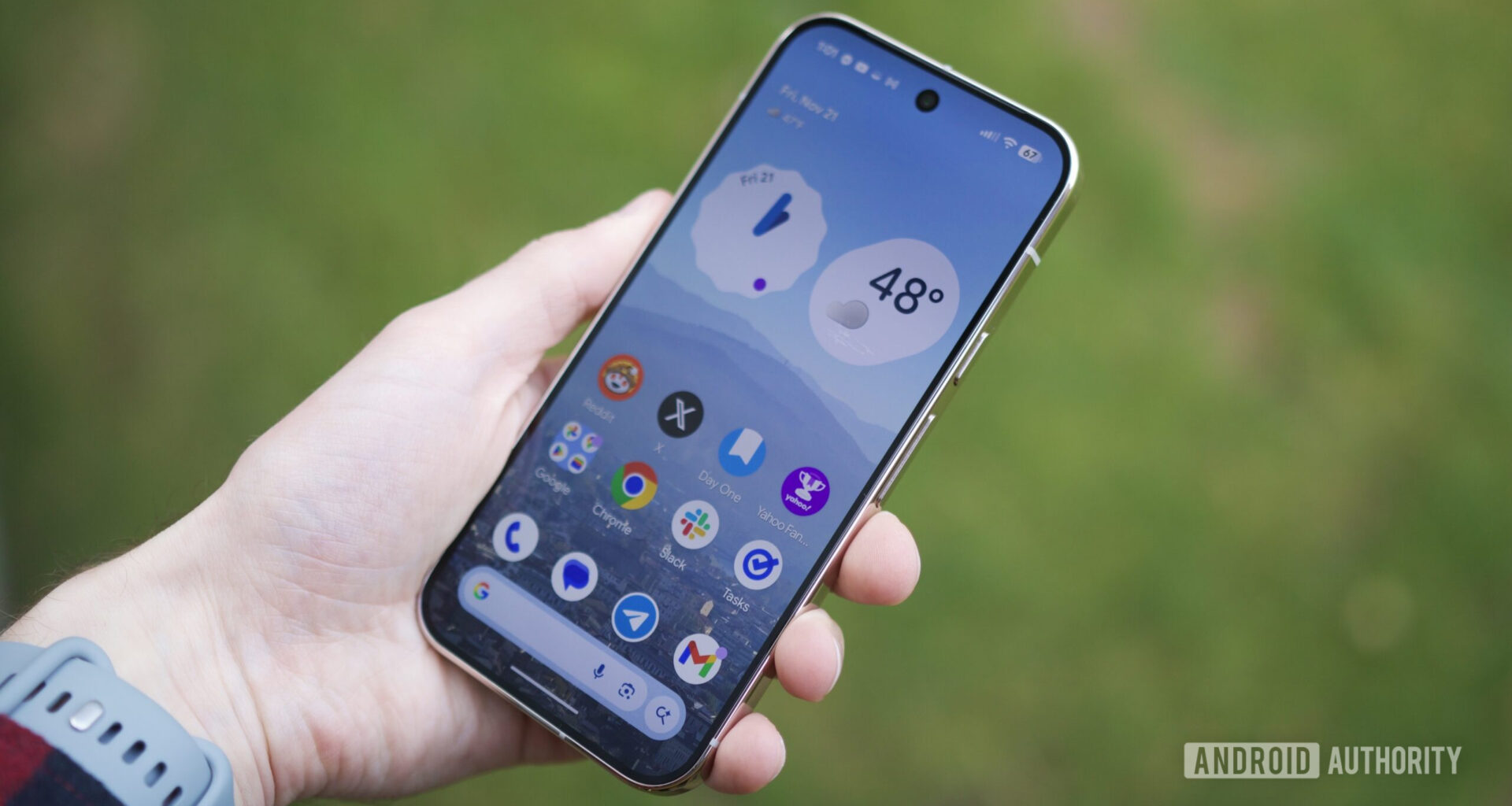 Someone holding a Pixel 10 Pro with its screen on.