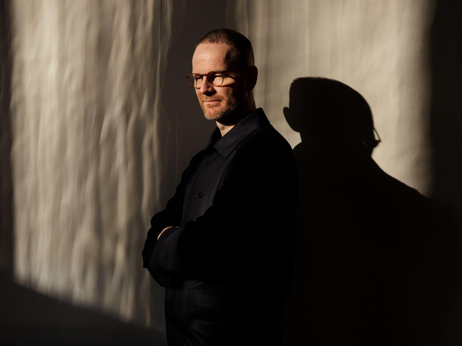 A man partially obscured by shadows