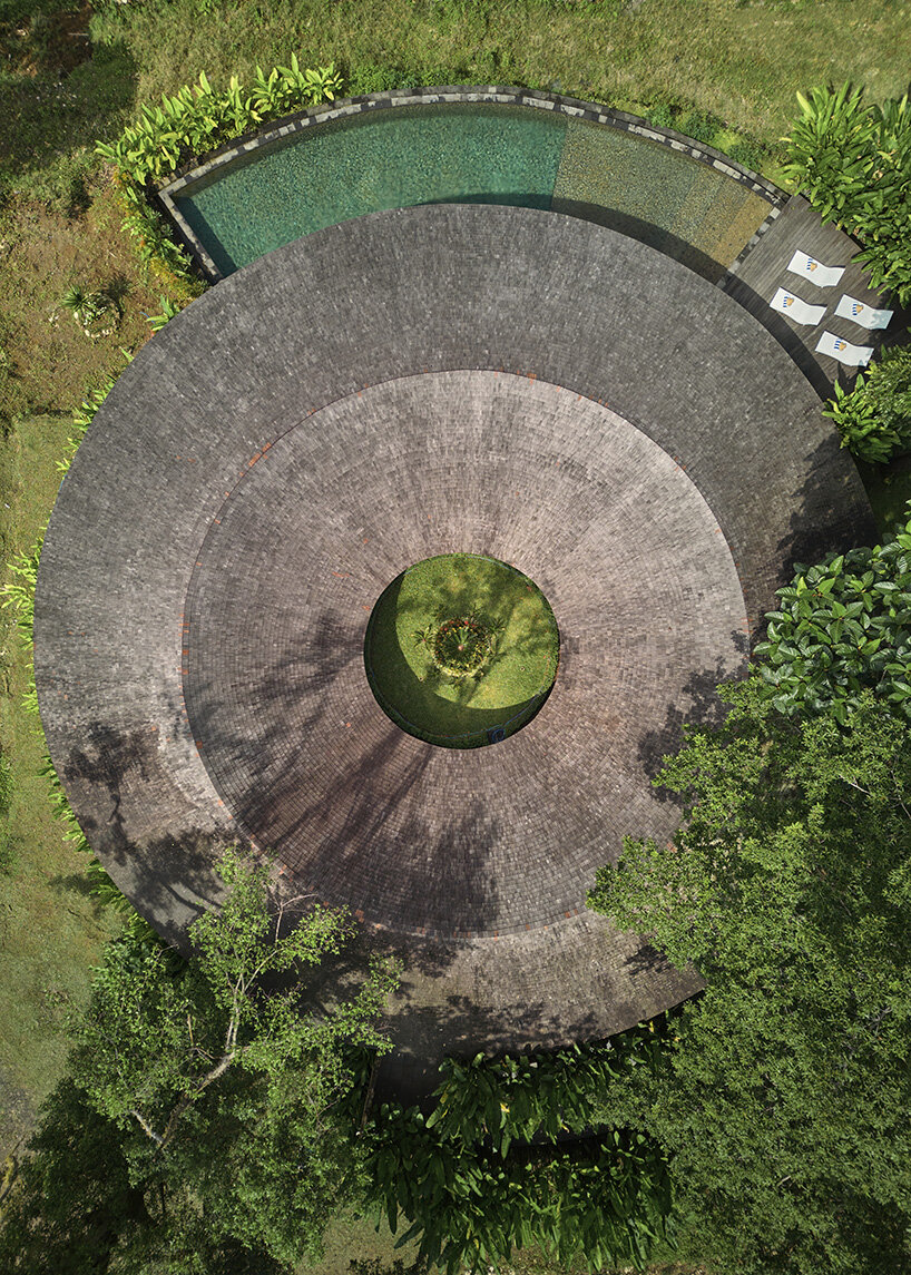 ring-shaped residence by alexis dornier wraps around verdant inner courtyard in bali