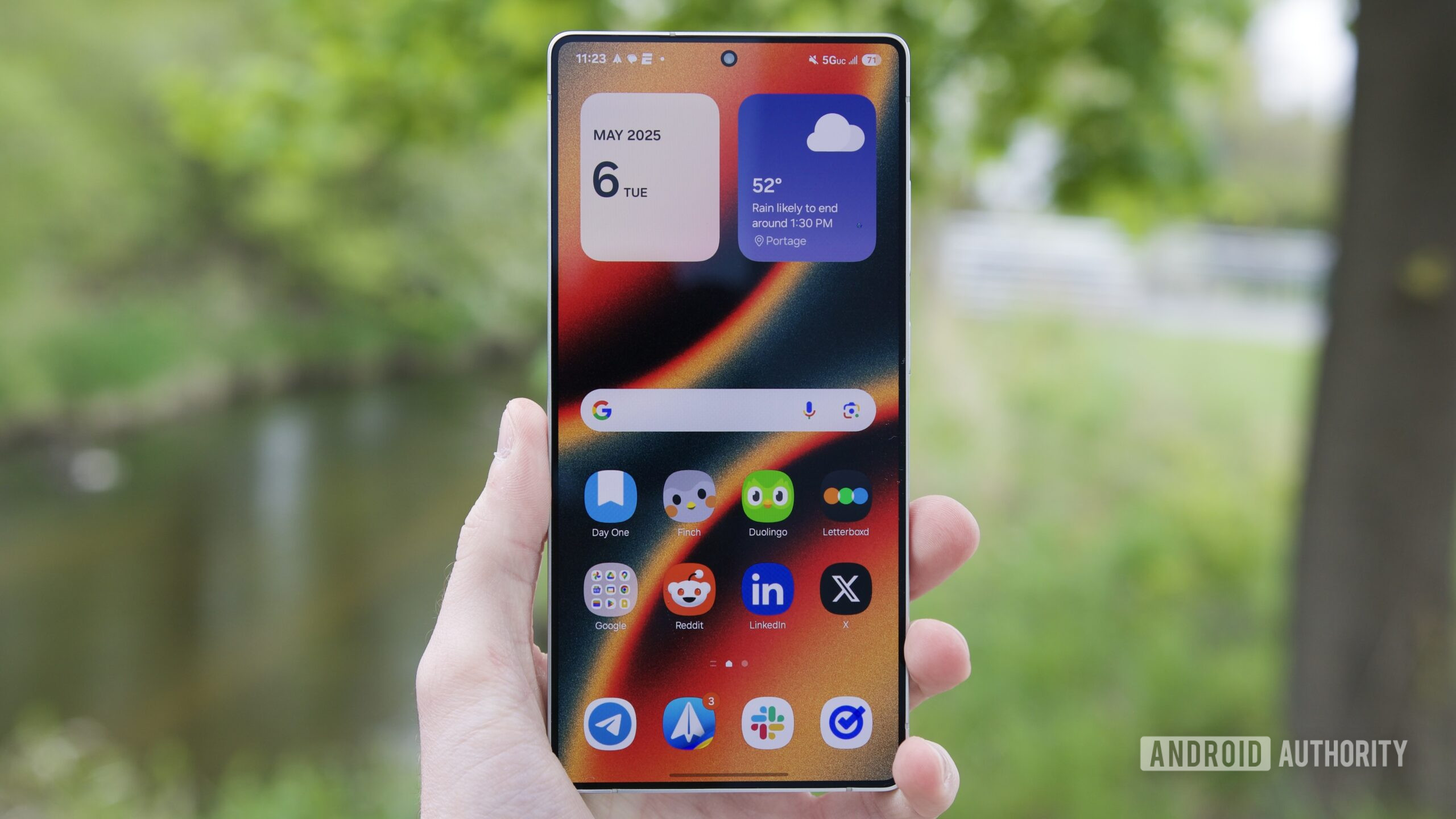 Someone holding the Samsung Galaxy S25 Ultra with its display turned on.