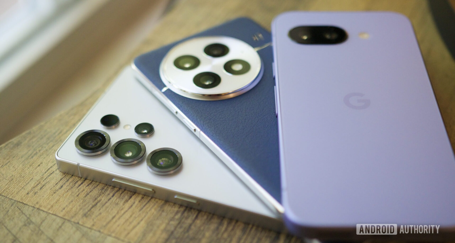 The Samsung Galaxy S25 Ultra, OnePlus 13, and Google Pixel 9a next to each other.