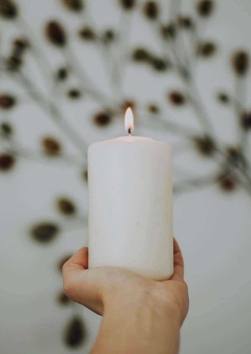 person holding a candle they paid extra for