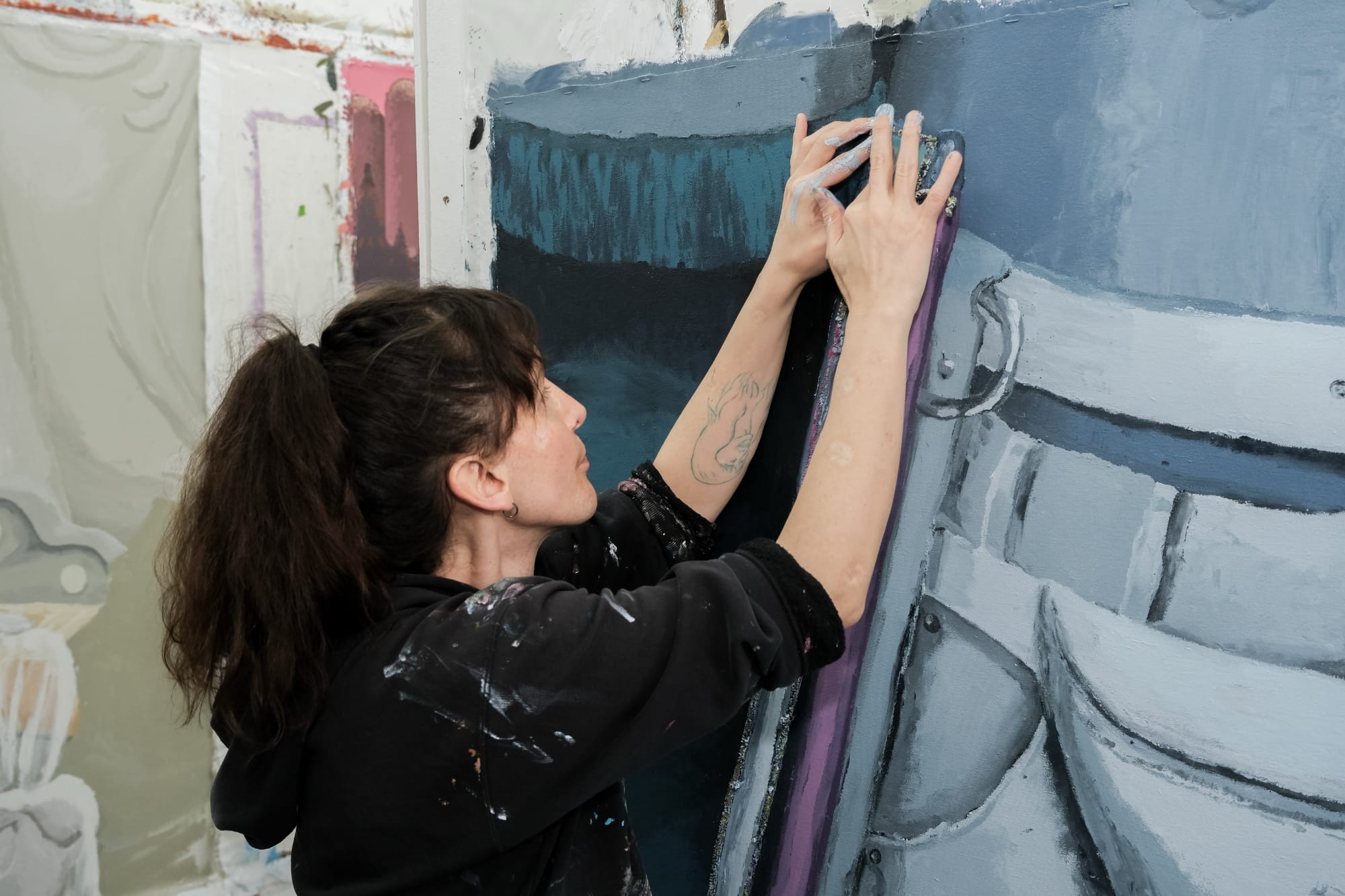 the artist works on a portrait through touch