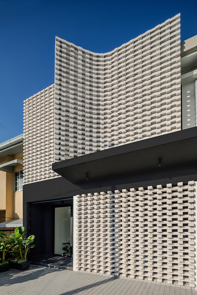 porous white brickwork facade enfolds renovated 1980s terrace house in kuala lumpur