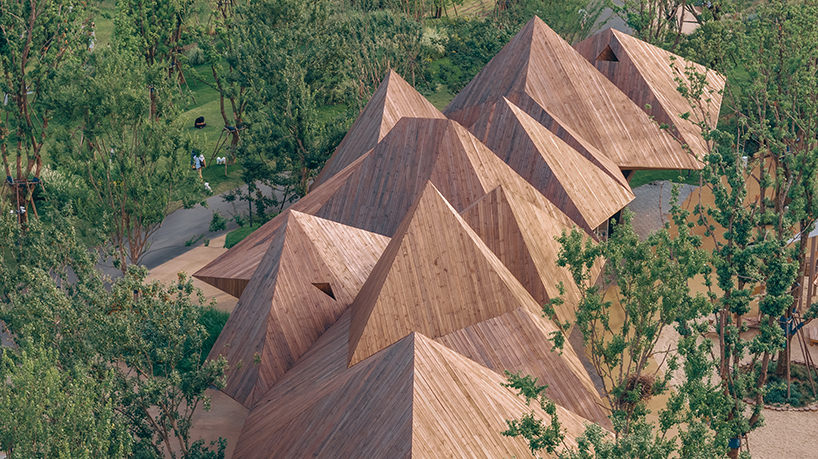 pyramidal volumes with wood strip patterns frame luxeisland restaurant by DL atelier